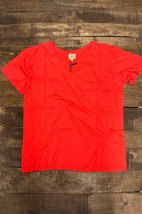 Wild Gypsy red pocket t-shirt laid flat on a rustic wooden background
