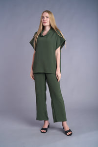 Woman wearing olive green two-piece relaxed set with short sleeves and wide-leg pants