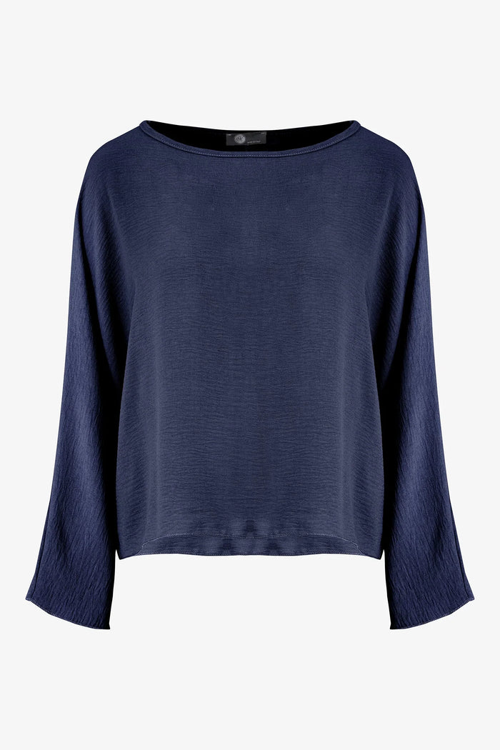 Front view of a women's navy relaxed fit long sleeve top with a round neckline